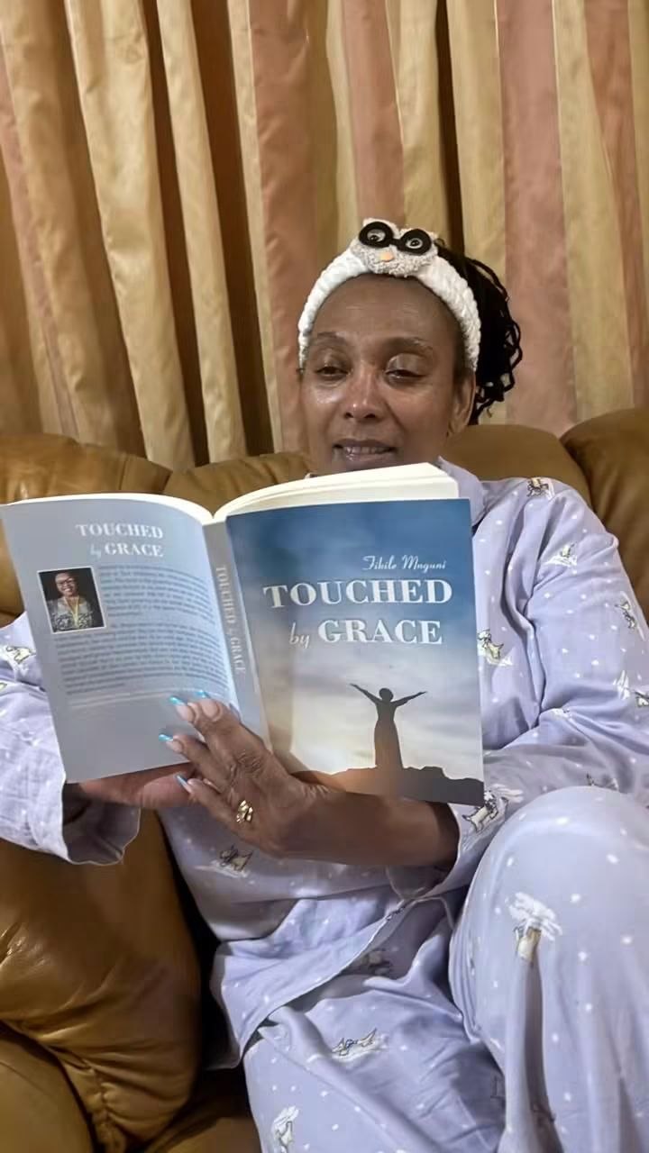 A reader curled up with her copy of Touched by Grace